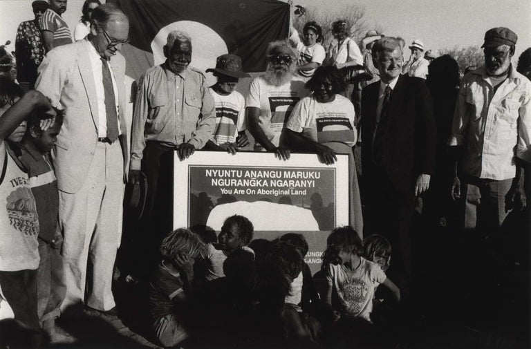 Item #CL179-143 Under Another Sky. Uluru Handback Ceremony, Sir Ninian Stephens, Hon. Barry Cohen With Traditional Owners And Their Children. Juno Gemes, b.1944 Aust.