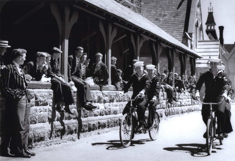 Item #CL185-173 US Navy Sailors Of “Operation Deep Freeze” Riding Their Tandems Through The Private Grounds Of Christ’s College, Christchurch [NZ]. Robin Smith, b.1927 NZ/Aust.