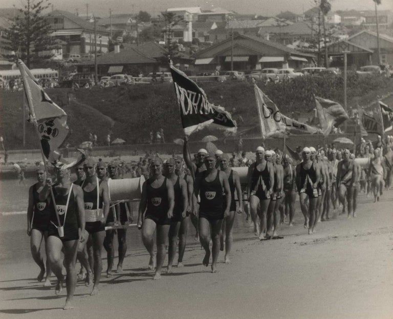 Item #CL185-62 [Surf Lifesavers’ March Past At Dee Why Beach, NSW]. Beverley Clifford, active 1950s-1970s Aust.