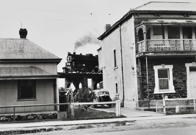 Item #CL191-137 Adelaide [Passing Train Glimpsed Between Two Homes]. Charles Page, b.1946 Australian.