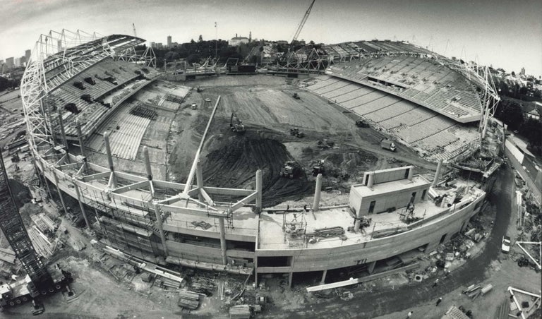 Item #CL207-46 New Sports Ground Under Way [Sydney Football Stadium, Moore Park, Under Construction]. Paul Mathews, b.1954 Aust.